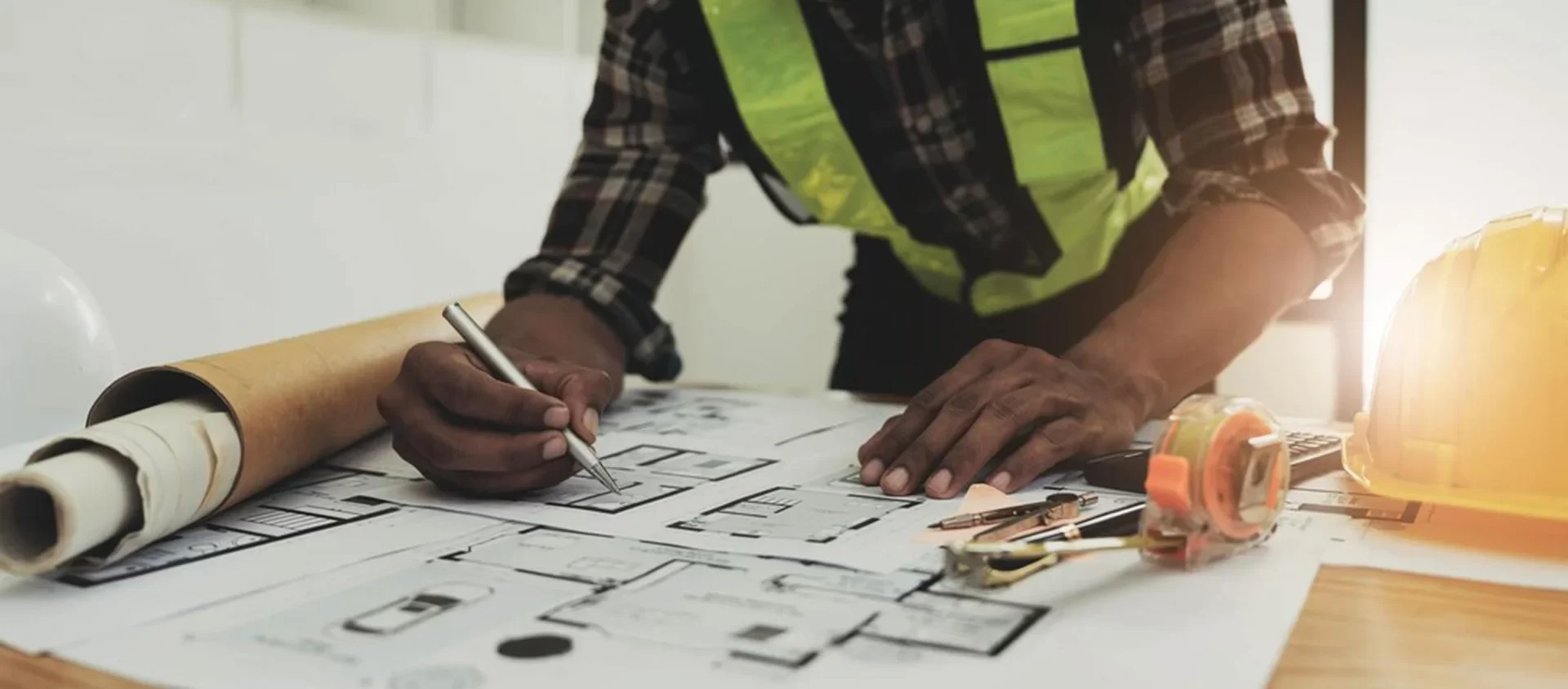 Bethel Trading Solutions civil male engineer working blueprint architectural project construction site